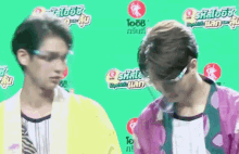 two young men are standing next to each other in front of a green background that says ' sr ' on it