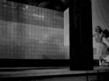 a woman in a white dress is dancing in front of a building