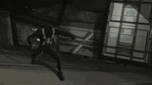 a black and white photo of a superhero in front of a building that says ' ii '