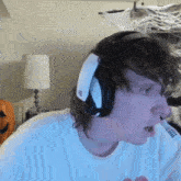 a man wearing headphones and a white shirt with a sticker on it that says ' i love you '