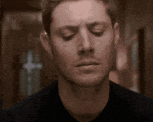 a close up of a man with his eyes closed .