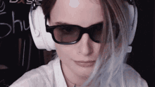 a woman wearing 3d glasses and headphones with the word shu written in the background