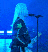 a person playing a guitar and singing into a microphone