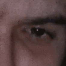 a close up of a person 's eye with a blurred background