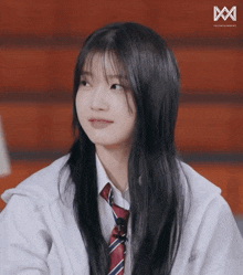 a girl with long black hair wearing a white shirt and red tie