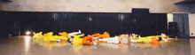 a group of people are laying on the floor in a dance studio