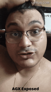 a man wearing glasses has agx exposed written on the bottom right