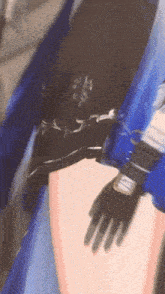 a close up of a person 's arm with a black glove on