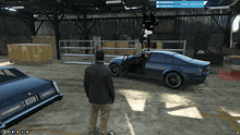 a man is standing in front of a car with a license plate that says e9 on the front