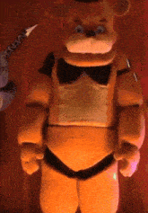 a stuffed teddy bear with a bow tie is standing in front of a red curtain and a pencil .