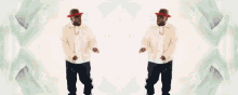 a man wearing a hat and sunglasses is dancing
