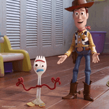 woody and forky from the movie toy story are standing next to each other