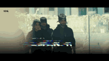 a group of people standing in front of a screen that says vyrl