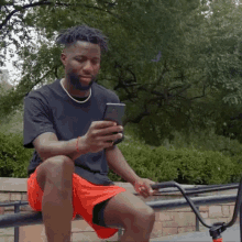 Laughing Nigel Sylvester GIF - Laughing Nigel Sylvester Looking At Phone GIFs
