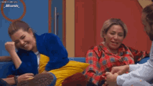 a group of people are sitting on a couch and one of them has a beard