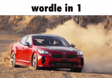 a red car is driving down a dirt road with the words wordle in 1 written above it