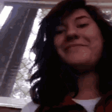 a close up of a woman 's face with a smile on her face .