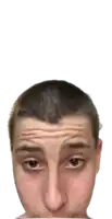 a man with a shaved head looks at the camera