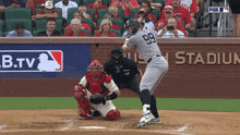 a baseball player with the number 99 on his jersey is swinging at a pitch