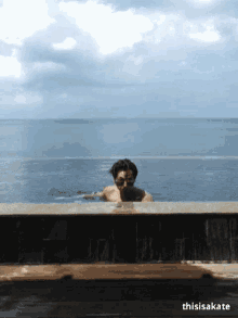 a man is swimming in a pool with the words thisisakate written below him