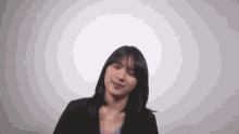 a woman with short hair is making a funny face against a white background .