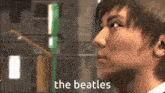 a close up of a man 's face with the words " the beatles " below him