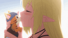 a girl with long blonde hair is kissing a stuffed cat