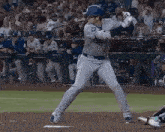 a baseball player is swinging a bat at a ball while standing on a baseball field .