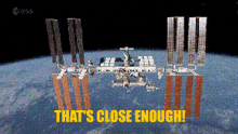 a picture of a space station with the words that 's close enough