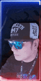 a man wearing a hat that says ' brooklyn ' on it