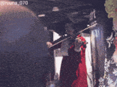 a woman in a red dress is playing a violin