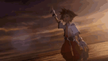 sora from kingdom hearts is flying through the air while holding a sword .