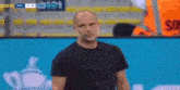 a man in a black shirt is standing in front of a screen that says ' so ' on it