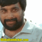 a close up of a man with a beard and the website globaltamilchat.com