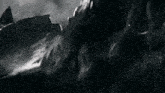a black and white photo of a rocky cliff with a shark in the background .