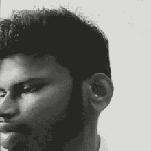 a black and white photo of a man 's face