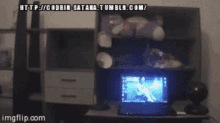 a man stands in front of a computer screen that says http://coorin-satan.tumblr.com/ on it