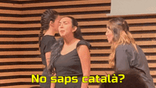 a woman kisses another woman on the cheek with the words no saps catalana behind her