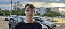 a boy wearing glasses is standing in front of a billboard that says ' a few days ago ' on it