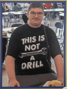 a man wearing a shirt that says " this is not a drill "