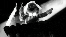 a black and white photo of a stuffed animal wearing a beaver mask .