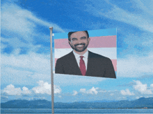 a transgender flag with a picture of a man in a suit and tie