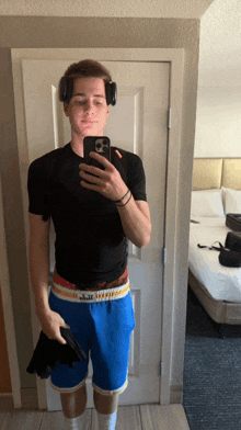 a man taking a picture of himself with headphones on his head