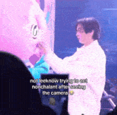 a man in a white shirt is touching a stuffed animal with the caption not leeknow trying to act nonchalant