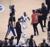 a group of people are standing around a basketball player on a basketball court .