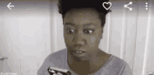 a woman is holding a cell phone in her hand .