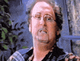 a man with glasses and a mustache is making a face