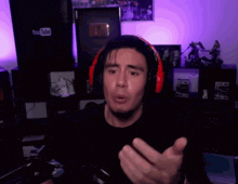 a man wearing red headphones stands in front of a youtube logo