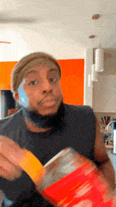 a man with blue paint on his face is holding a bag of food