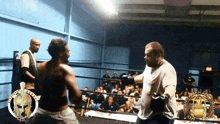 two men in a boxing ring with a spartan helmet on the corner